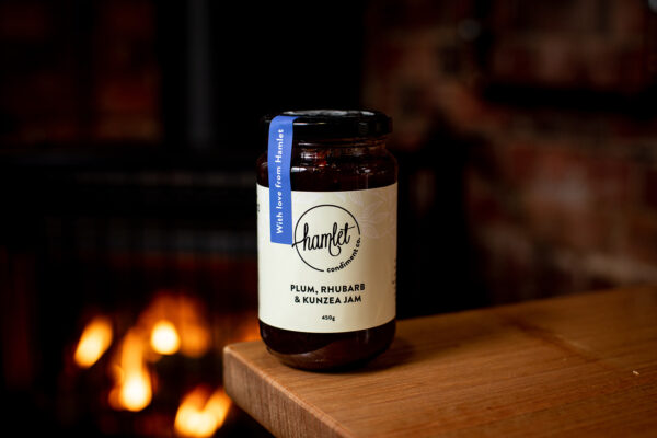 A 450g glass jar of plum, rhubarb and kunzea jam, with a seal sticker over the lid that reads With love from Hamlet.