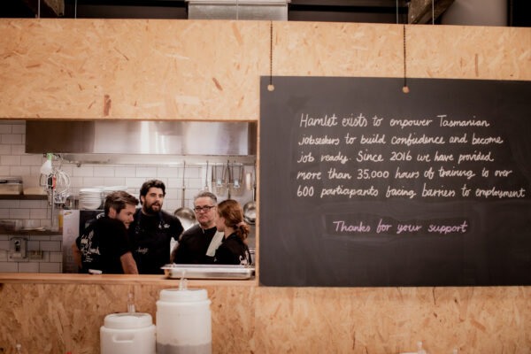 Group of Hamlet's chefs standing in the kitchen talking to Italian-Australian chef Guy Rossi.