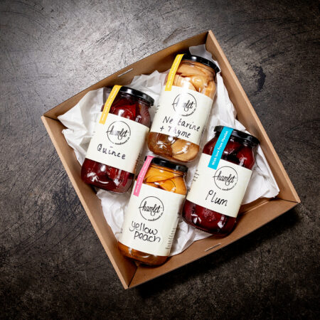 A hamper filled with Hamlet's Condiment Co's Quince, Nectarine and Thyme, Plum, and Yellow Peach. The jars are sealed with a sticker over the lid that reads With love from Hamlet.