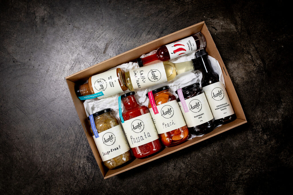 A large hamper containing a selection of Hamlet's pantry essentials including Nectarine Plum Sauce, Kaffir Lime Cordial, Hot Sauce, Sauerkraut, Passata, Peach, Raspberry Jam and Greengage Worcestershire Sauce.